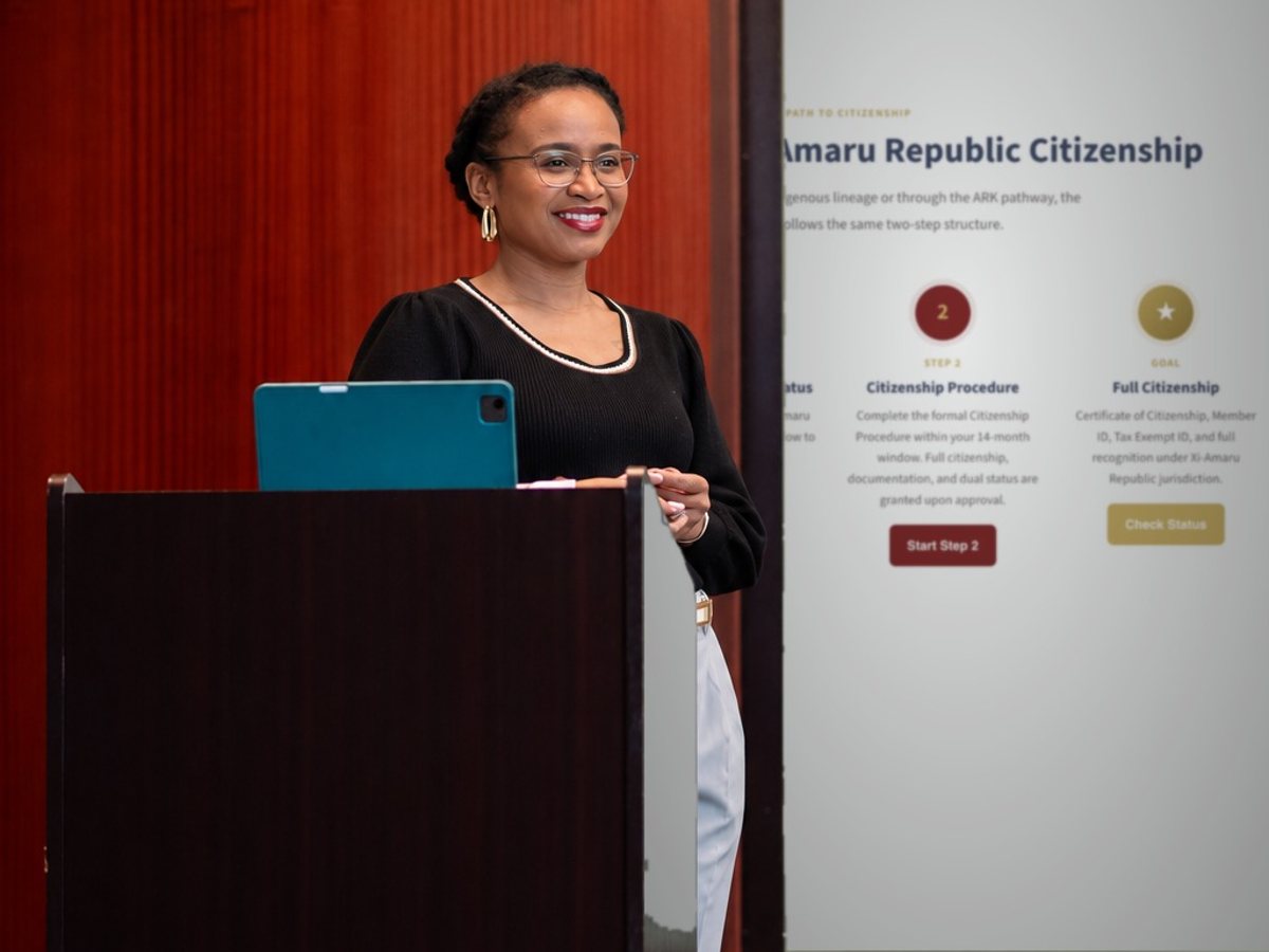Chief Nnakina at a podium presenting the AMJ citizenship steps